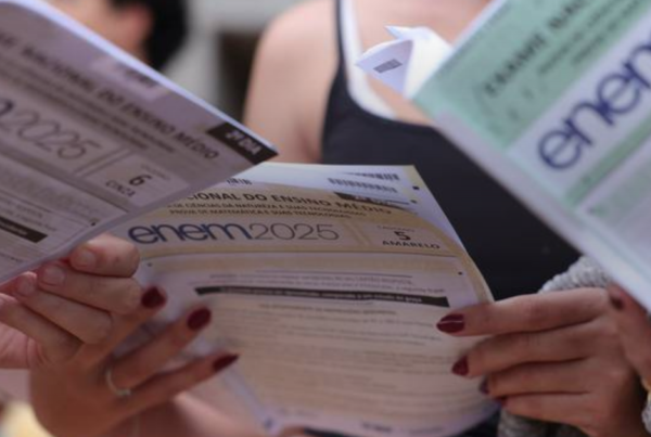 Candidatos segurando os cadernos de prova do Enem 2025